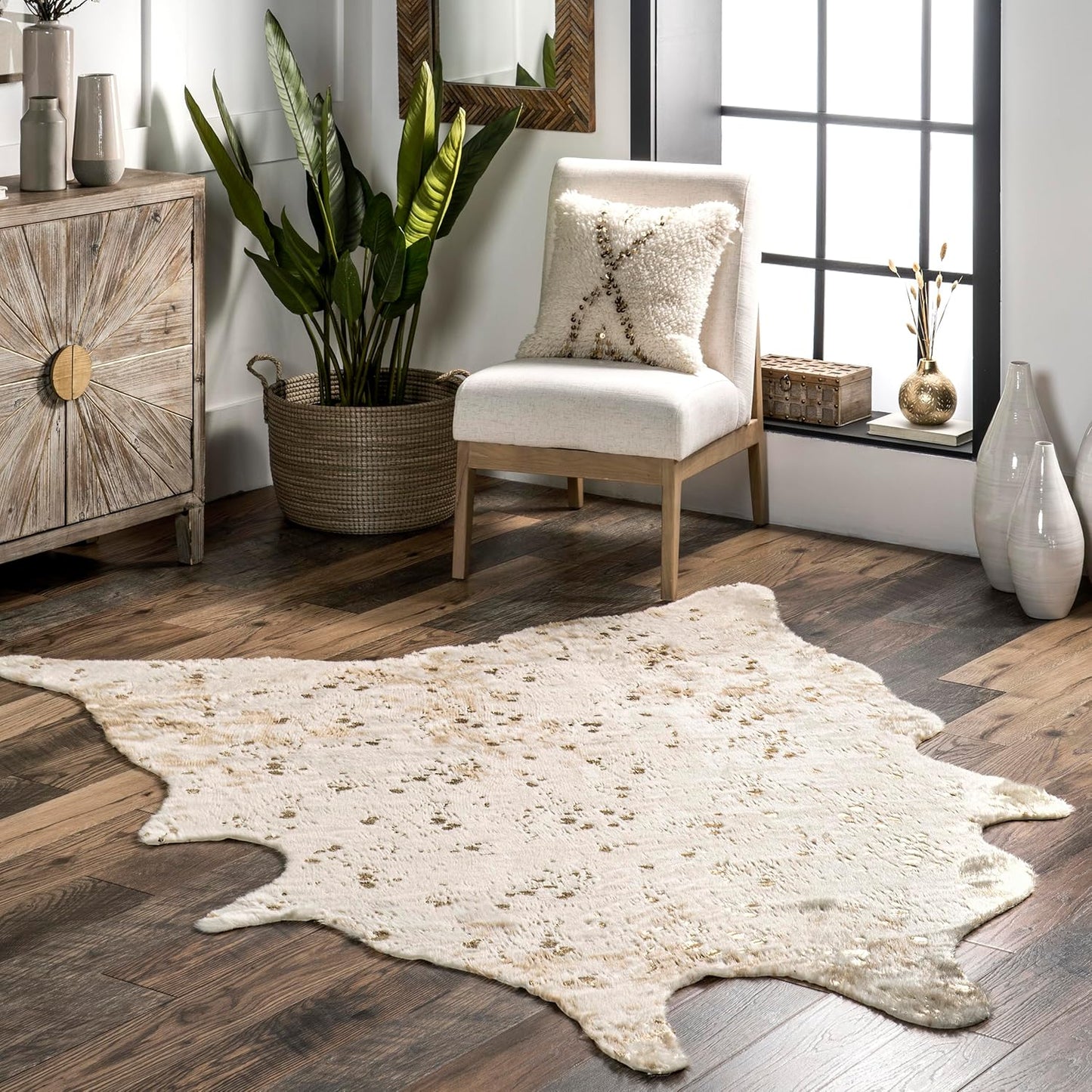 Ivory and gold faux hide rug with metallic flecks styled in a cozy corner with wood floors and neutral decor, perfect for dorm living.