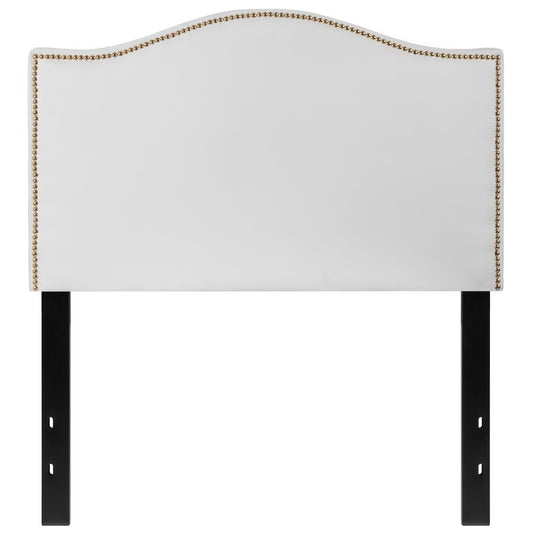 White dorm headboard with gold studs.