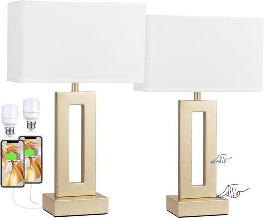 Gold rectangular touch lamps with USB charging ports and soft white shades on a nightstand.
