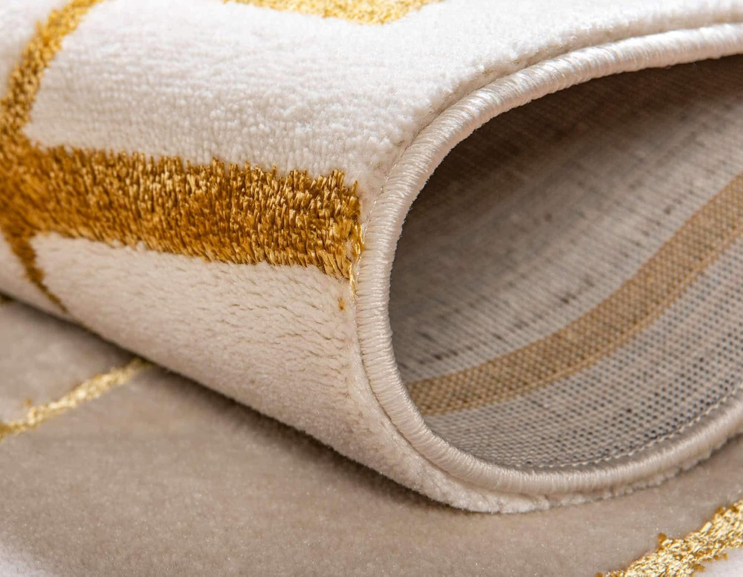 Side view of glam deco rug with gold accents for an elevated dorm room setting. 